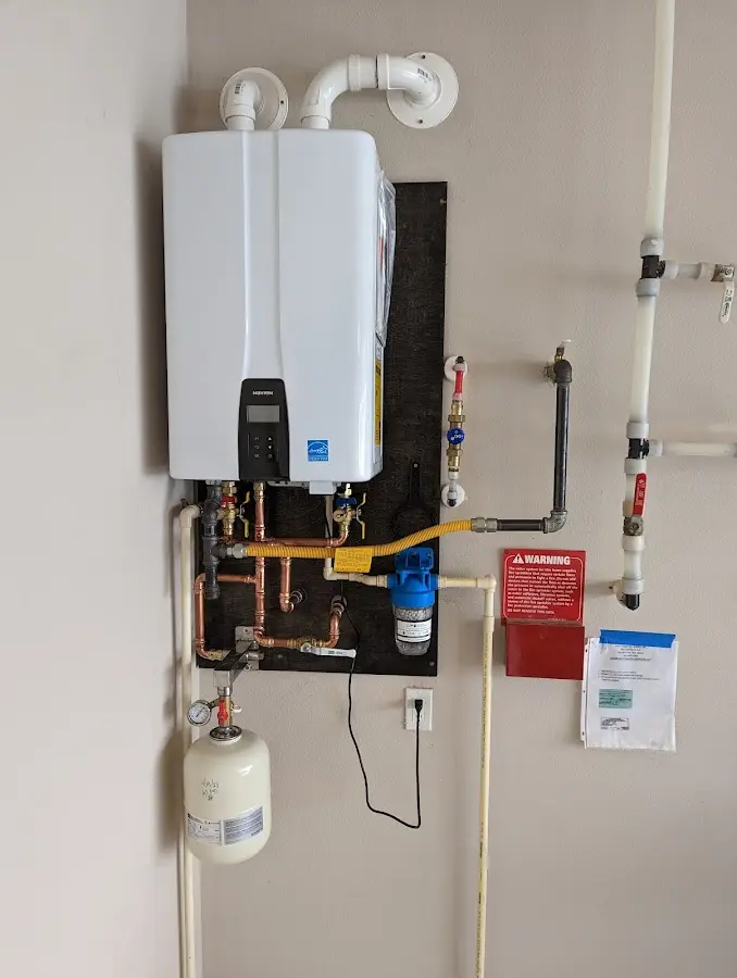 Professional plumber installing copper piping in a Sutton home